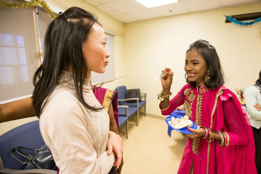 Popi Rani Das, right, shares some cake with Dr. Toni Zhong at a party thrown for Das following her successful surgery at Toronto General Hospital.