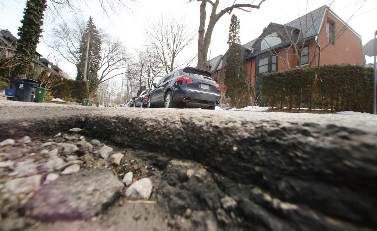 A pothole graces a street in the west-end “Republic of Rathnelly” neighbourhood, near Casa Loma. It's the number two neighbourhood in the city for complaints about potholes to 311 — and the site of last year’s infamous pothole tomato plants.